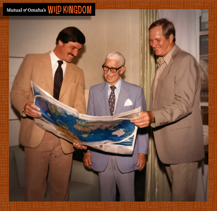 Wild Kingdom hosts Marlin Perkins, Jim Fowler, and Peter Gros looking at a now outdated map